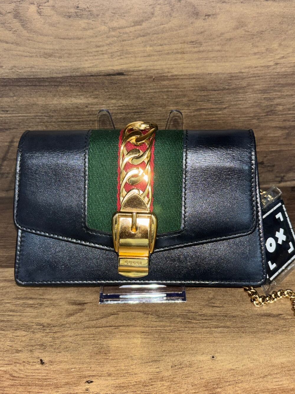 Gucci Sylvie Chain Super Mini shoulder bag in black leather.